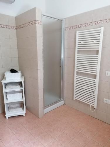 a bathroom with a shower and a glass door at Monica appartamenti in San Vincenzo