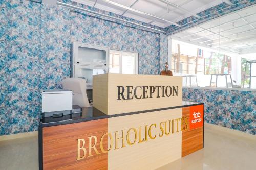 an office with a reception desk and a sign at FabHotel Broholic Suites - Nr US Consulate, Financial District in Hyderabad
