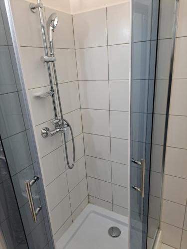 a bathroom with a shower with a glass door at Apartmán pri Sokolovni in Martin