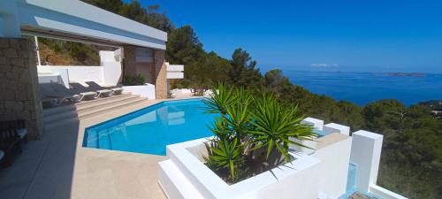 a villa with a swimming pool and a view of the ocean at Ibiza 7th Heaven Villa in Sant Josep