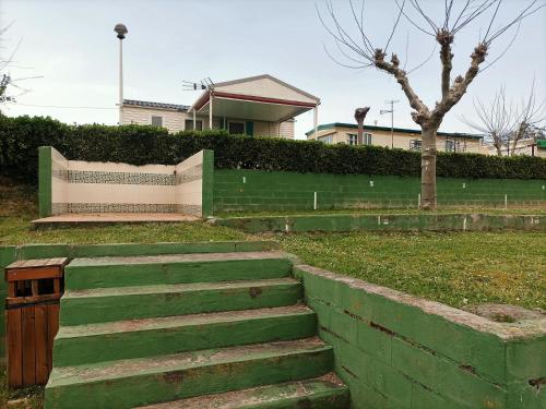 a set of stairs in front of a house at Camping Mola! Surf Loredo in Loredo