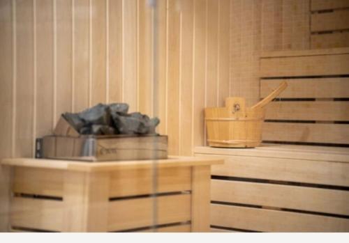 a sauna with a wooden table and a wooden box at Very Sweet apartment in Palisad