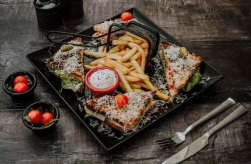 a plate of food with a sandwich and french fries at Very Sweet apartment in Palisad