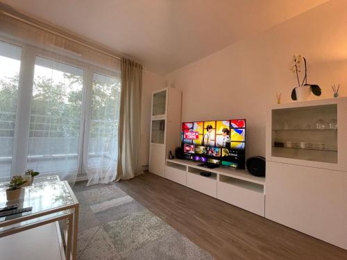 a living room with a flat screen tv on a wall at Lovely apartment near to Paris in Créteil