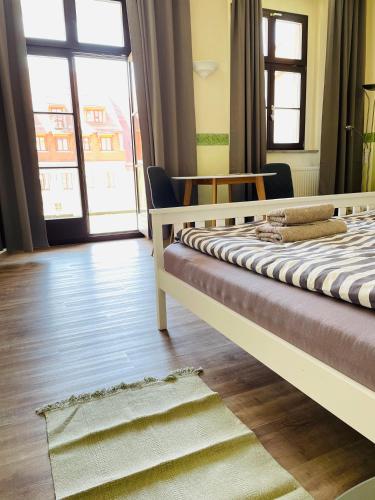a bedroom with a bed and a large window at Apartment Sonnenterrasse in Bautzen