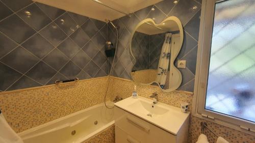 ベナルマデナにあるCALAMORRO viewsのバスルーム(シンク、バスタブ、鏡付)