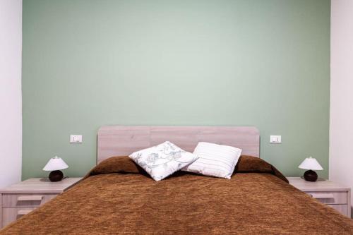 a bed with two pillows on top of it at Celia’s House in Lezzeno