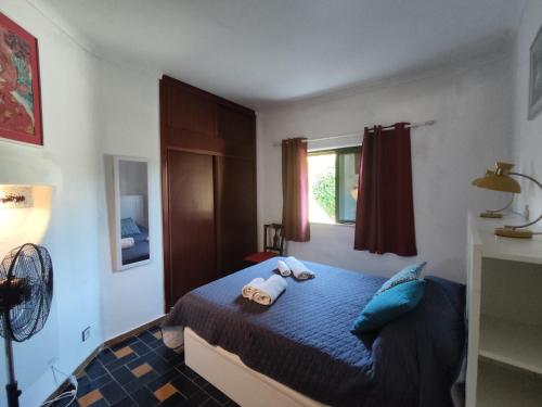 a bedroom with a bed with two stuffed animals on it at 6 Mourisca - Casas & Papéis in Lagoa