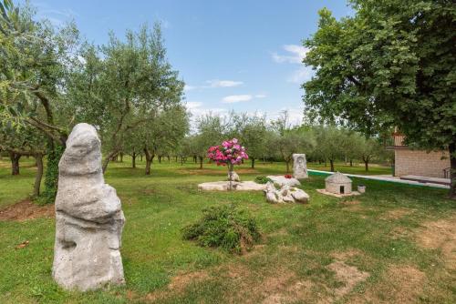 a group of stone statues in a park at Apartment Luma in Vižinada