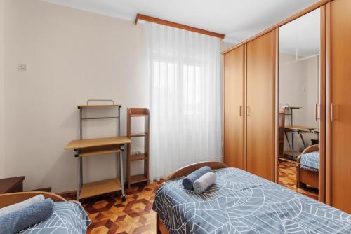 a bedroom with a bed and a desk and a mirror at Apartment Luma in Vižinada
