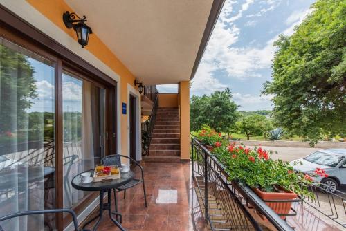 a balcony with a table and some flowers at Apartment Luma in Vižinada