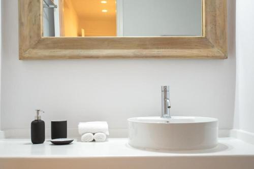 a bathroom counter with a sink and a mirror at Villabellum Mykonos in Mikonos