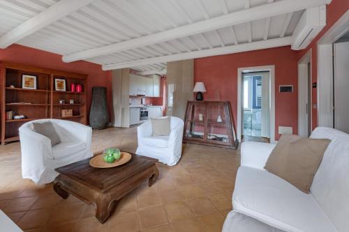 a living room with white furniture and a table at Le Versegge Resort in Braccagni