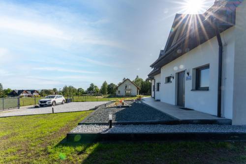 a house with the sun shining on the side of it at Domki Słoneczna 11 z widokiem na Śnieżkę in Karpacz