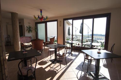 un restaurant avec tables et chaises avec vue dans l'établissement Il Corbezzolo, à Ripatransone