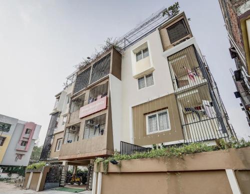 a tall building with barred windows on a street at Super Capital O Sayhallo Prime Residency in Bhubaneshwar