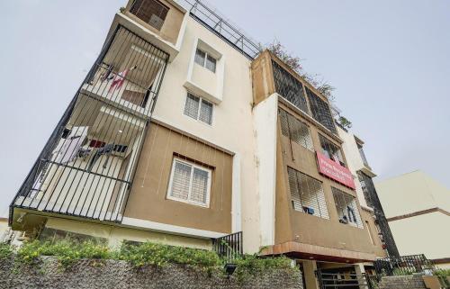 a tall building with barred windows and a balcony at Super Capital O Sayhallo Prime Residency in Bhubaneshwar