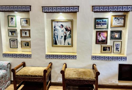 a room with a bunch of pictures on the wall at The Kaptain's Retreat in Chandīgarh