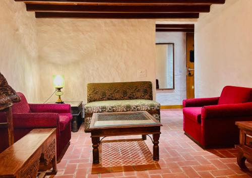 a living room with a couch and a coffee table at The Kaptain's Retreat in Chandīgarh