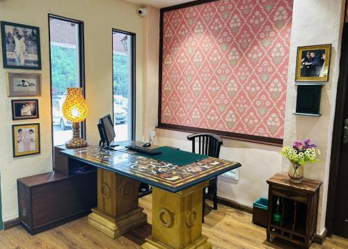 an office with a desk with a computer on it at The Kaptain's Retreat in Chandīgarh