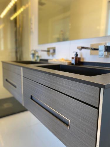 a kitchen with a sink and a counter top at DÚPLEX DE LUJO EN FOZ CON VISTAS al MAR in Foz