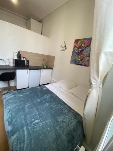 Superbe appartement centre ville chez Tony في بيريجو: غرفة نوم مع سرير وبطانية زرقاء