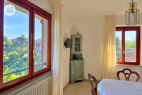 a room with a bed and a window with a view at Agriturismo Irto Colle in Massa e Cozzile