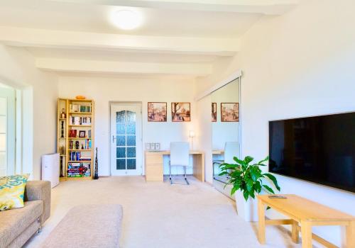 a living room with a couch and a table at Apartmán u Berounky in Beroun