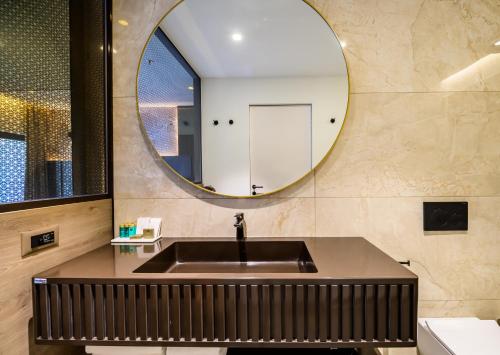a bathroom with a sink and a mirror at Marinus Beach Hotel in Marina