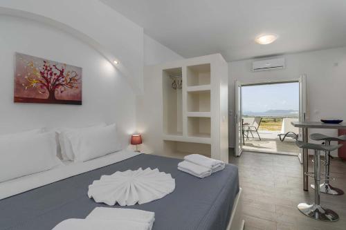a bedroom with a bed with an umbrella on it at Sunset Village 6 in Paleochori