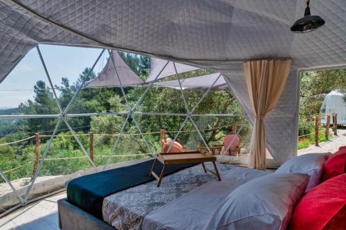 a room with a bed and a large window at luxury dome tents ikaria ap'esso2 in Raches