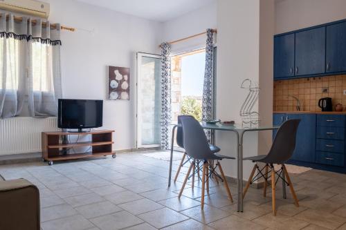 a kitchen with a glass table and chairs at Casa Fabrica in Ano Syros