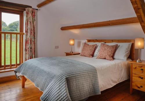 a bedroom with a large bed and a window at The Granary in Bideford