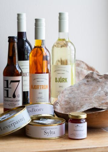 a group of bottles of wine and bread on a table at Sikfors Herrgård in Hällefors