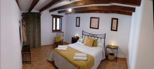 a bedroom with a large bed in a room at El Rincón de BeBa in Segura de la Sierra