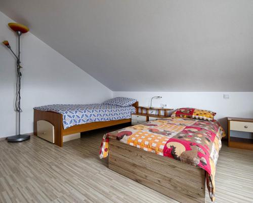 a bedroom with two beds and a lamp at Apartma Hilltop Haven in Šmarje pri Jelšah