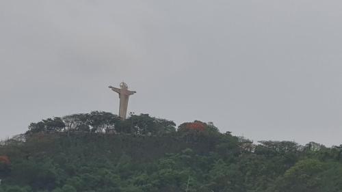 a cross on top of a hill with trees at Hotel Hoai Anh in Vung Tau