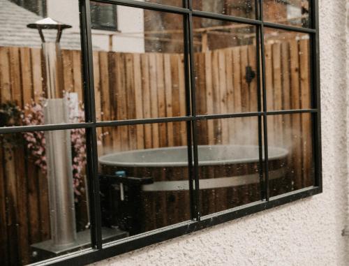 a window with a reflection of a tub in it at The Old Brewery, Ulverston in Ulverston