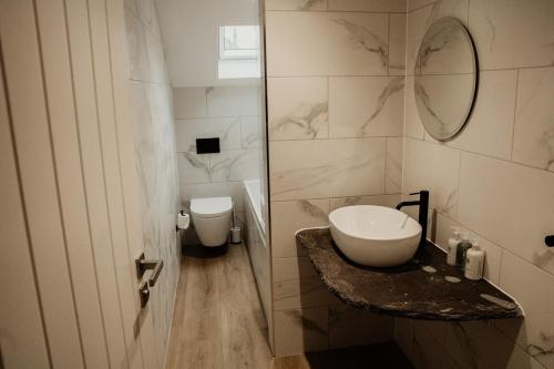 a bathroom with a sink and a toilet at The Old Brewery, Ulverston in Ulverston