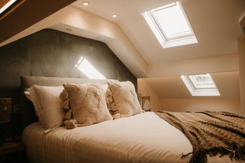 a bedroom with a large bed with skylights at The Old Brewery, Ulverston in Ulverston