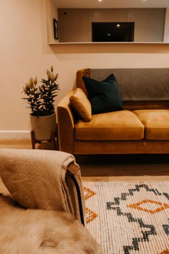 a living room with a couch and a tv at The Old Brewery, Ulverston in Ulverston