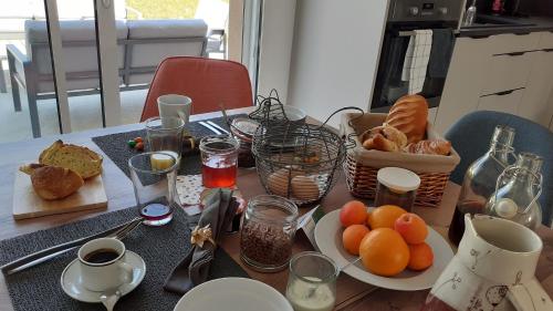 a table with a plate of bread and fruit on it at L'Epicurienne in Simandre