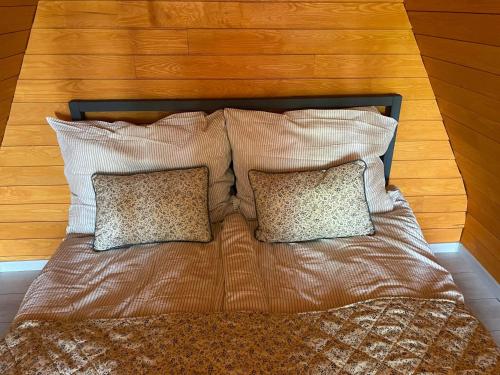 a bed with two pillows on top of it at Makkocska Vendégház in Noszvaj