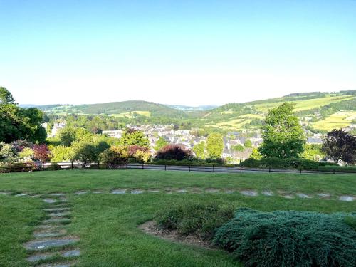 a grassy field with a view of a city at La Borzeux in Stavelot