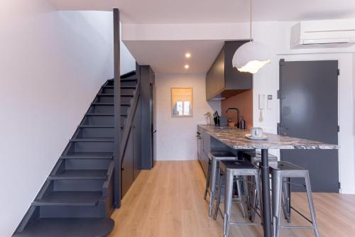 une cuisine avec un escalier menant à un loft dans l'établissement Duplex Pradignac by Halldis, à Cannes