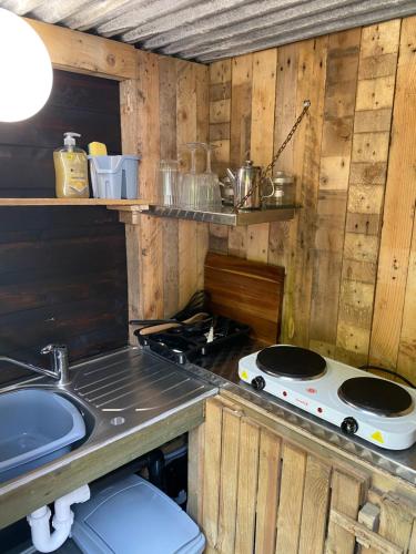 a kitchen with a stove and a counter top at Bluebell bell tent The Roaches in Upper Hulme