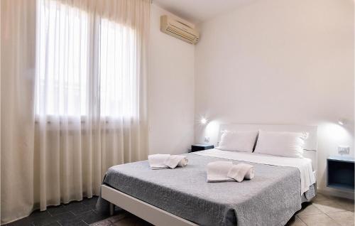 a bedroom with a bed with two towels on it at Villa Mucera in Ficarazzi