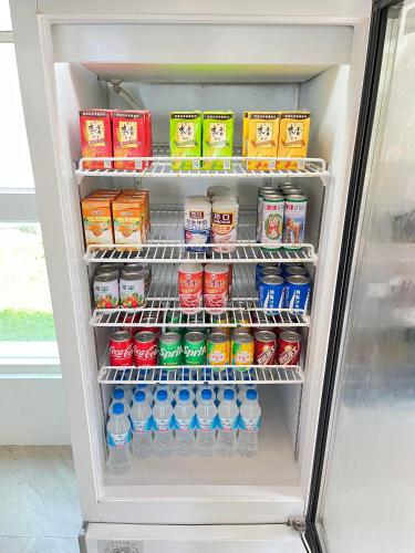 a refrigerator filled with lots of drinks and soda at Cest La Vie in Eluan