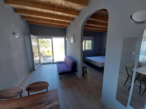 a room with a bed and a couch and a table at Ktima Argiri in Ormos Panagias