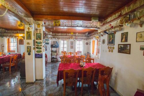 a restaurant with tables and chairs with red table cloth at комплекс Щастливците in Starozagorski Bani